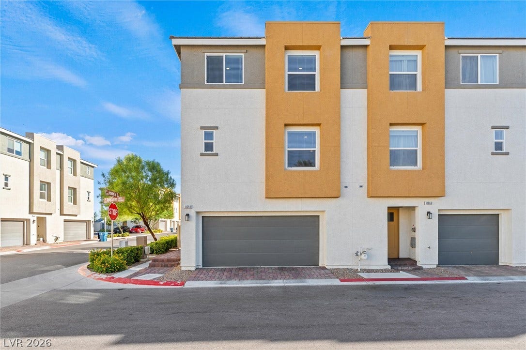 10059 Dazzling Sunrays Avenue, Las Vegas, NV 89129 Modern multi-level exterior architecture features stucco finishes and private garage access.