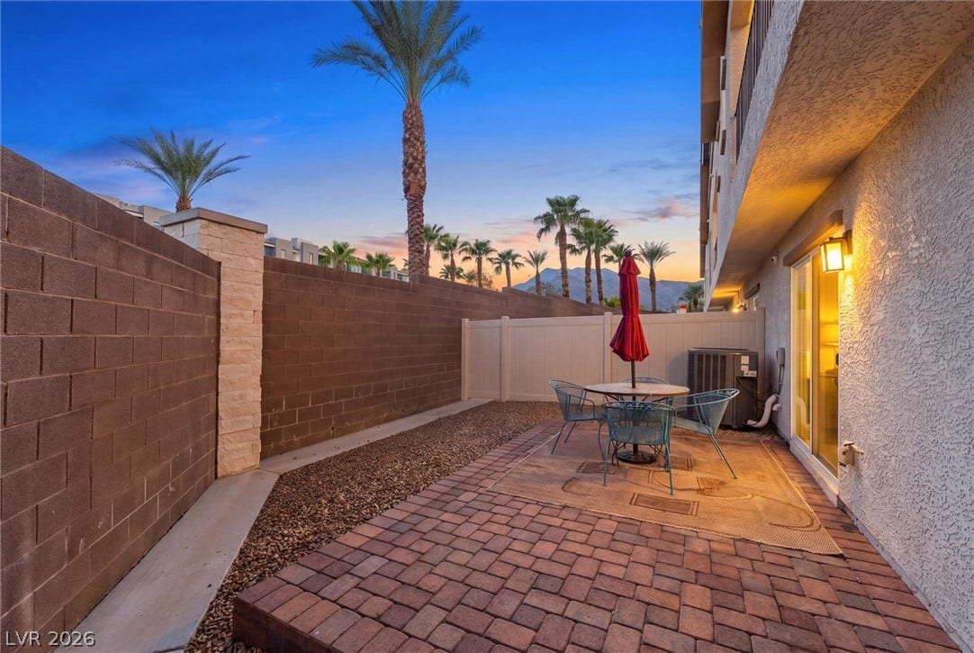 10059 Dazzling Sunrays Avenue, Las Vegas, NV 89129 An enclosed brick paver courtyard provides a private outdoor retreat framed by scenic palm trees.