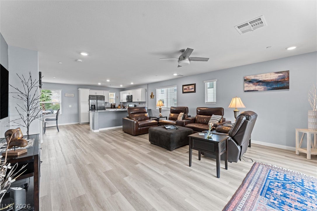 10059 Dazzling Sunrays Avenue, Las Vegas, NV 89129 An open floorplan seamlessly connects the airy living area to the adjacent modern kitchen.