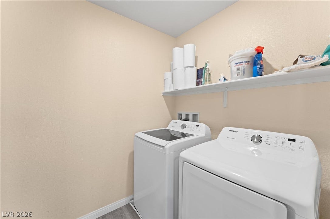 10059 Dazzling Sunrays Avenue, Las Vegas, NV 89129 Functional laundry setup highlights clean lines and built-in shelving above modern appliances.