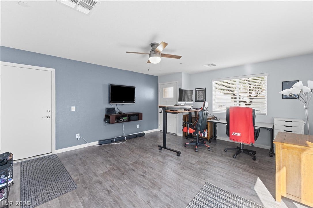 10059 Dazzling Sunrays Avenue, Las Vegas, NV 89129 Durable wood-look flooring and recessed trim ground this versatile home workspace.