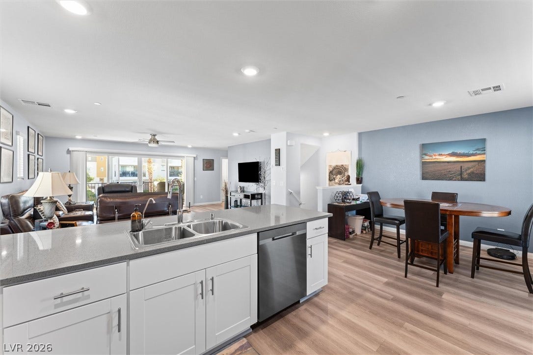 10059 Dazzling Sunrays Avenue, Las Vegas, NV 89129 An open layout connects the kitchen, dining area, and living space over durable wood-look flooring.