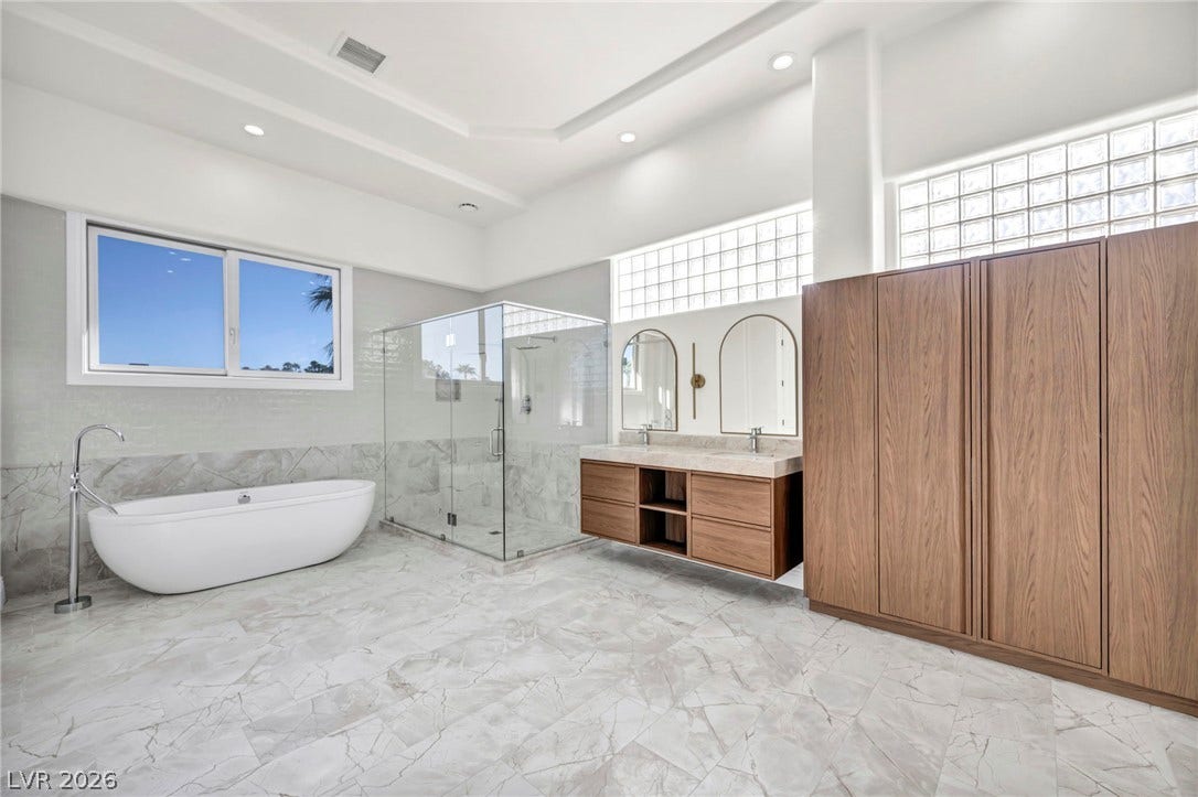 8805 Spanish Mountain Drive, Las Vegas, NV 89148 Stone tile flooring and a freestanding tub define this contemporary primary bath oasis.
