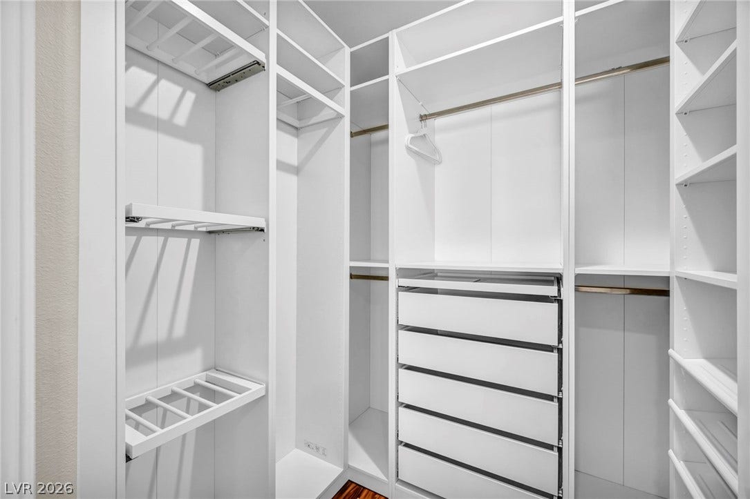 8805 Spanish Mountain Drive, Las Vegas, NV 89148 Custom shelving and hanging rods maximize storage in this spacious walk-in closet.