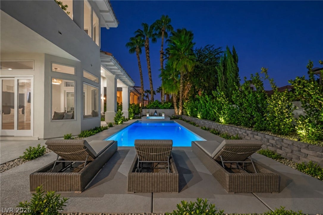 8805 Spanish Mountain Drive, Las Vegas, NV 89148 Glistening pool waters create a serene backyard oasis framed by manicured privacy hedges.