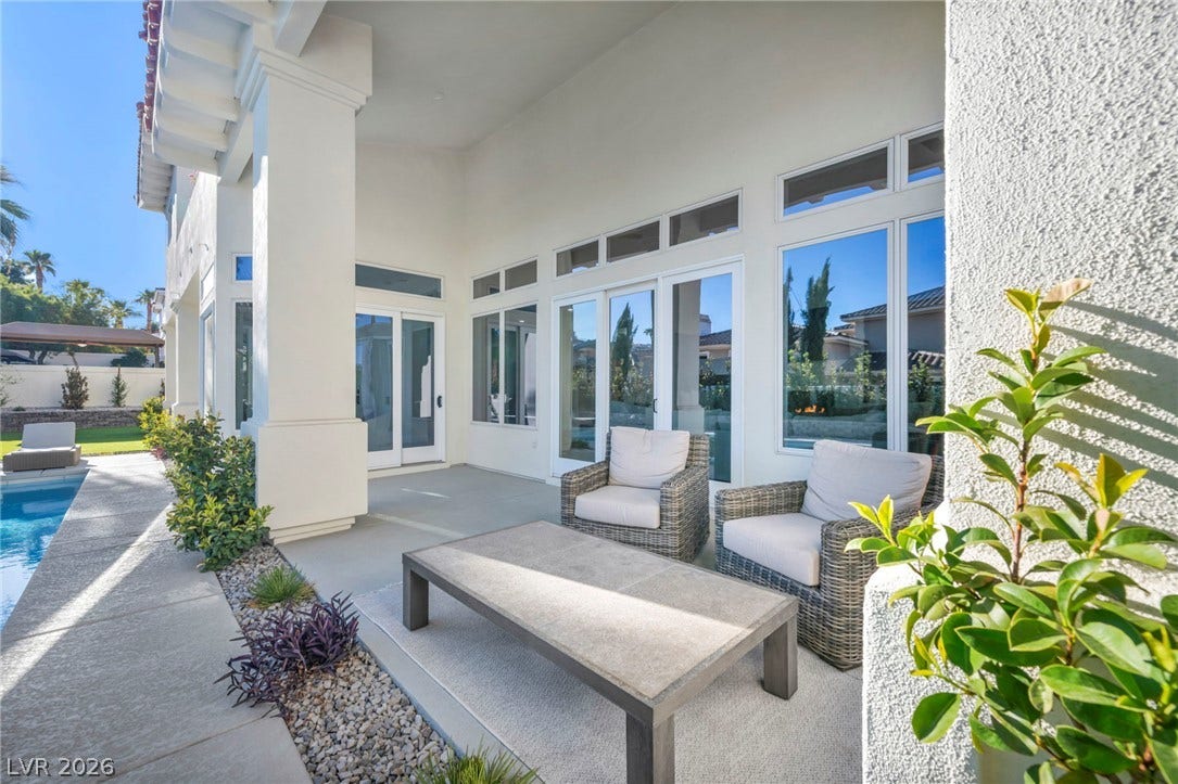 8805 Spanish Mountain Drive, Las Vegas, NV 89148 An inviting covered patio offers seamless indoor-outdoor living overlooking a sparkling pool.