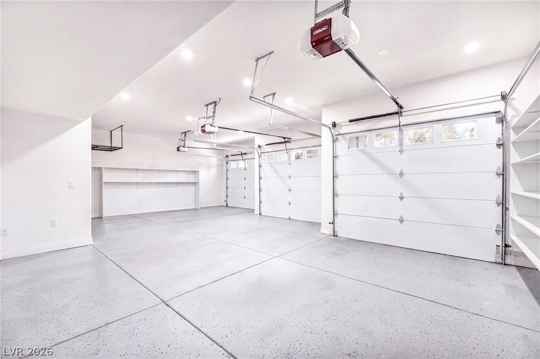 8805 Spanish Mountain Drive, Las Vegas, NV 89148 Clean epoxy floors and built-in shelving maximize organization in this expansive multi-car garage.