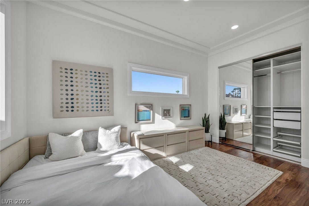 8805 Spanish Mountain Drive, Las Vegas, NV 89148 Recessed lighting, wood flooring, and a mirrored closet define this serene sleeping space.