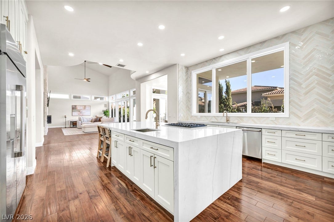 8805 Spanish Mountain Drive, Las Vegas, NV 89148 Rich hardwood floors complement the clean lines of this open, light-filled kitchen space.