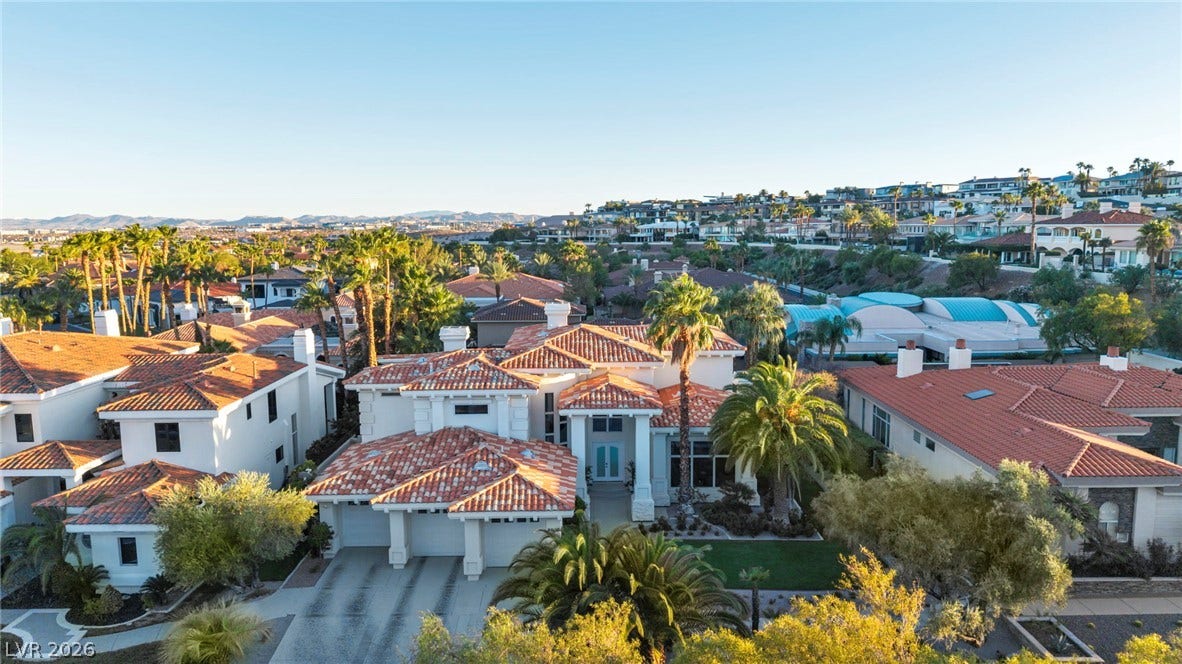 8805 Spanish Mountain Drive, Las Vegas, NV 89148 An elegant tile roof crowns this grand multi-level residence nestled among lush palms.