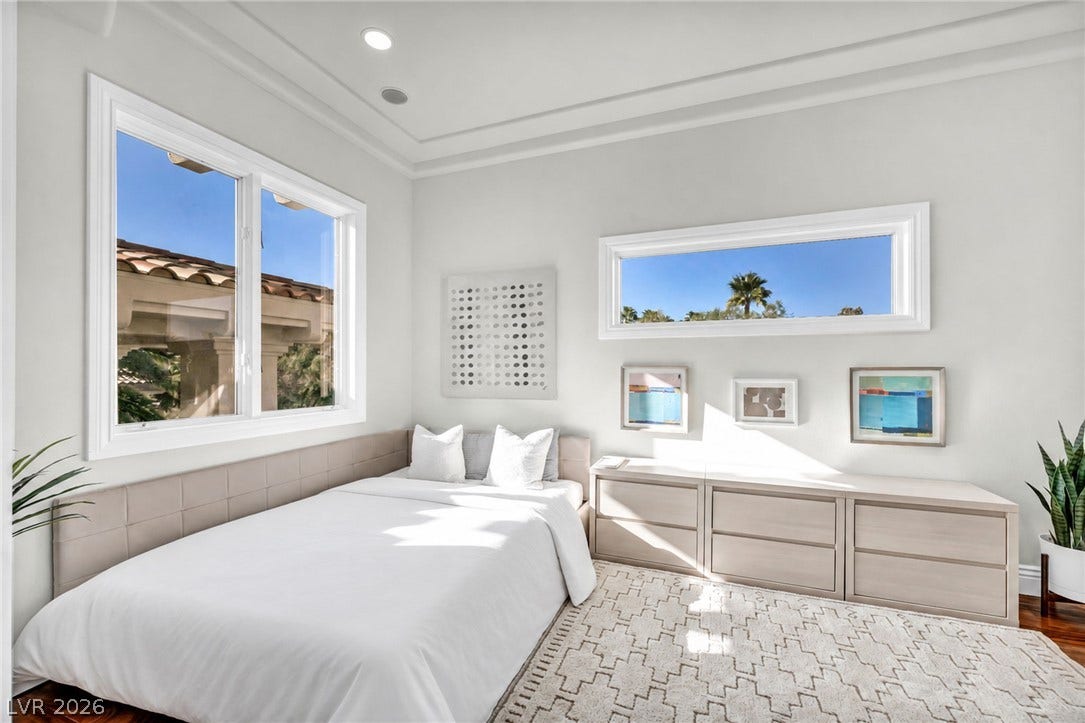 8805 Spanish Mountain Drive, Las Vegas, NV 89148 Gleaming wood floors and a tray ceiling frame this serene space illuminated by natural light.