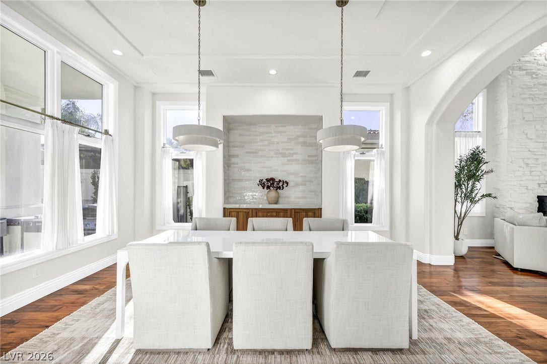 8805 Spanish Mountain Drive, Las Vegas, NV 89148 Rich hardwood flooring anchors the formal dining area beneath elegant tray ceilings.