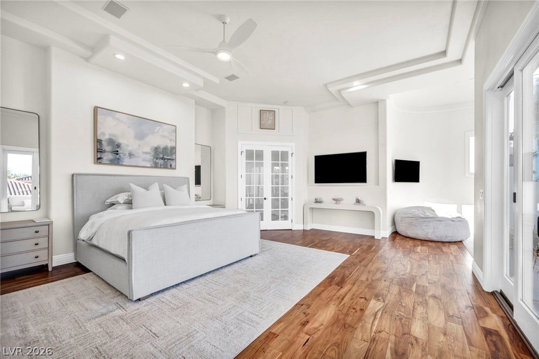 8805 Spanish Mountain Drive, Las Vegas, NV 89148 Rich hardwood floors and a recessed ceiling with lighting create a refined main bedroom retreat.
