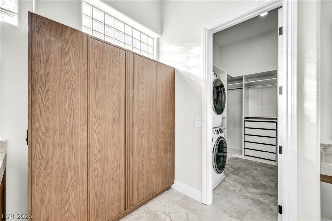 8805 Spanish Mountain Drive, Las Vegas, NV 89148 Rich wood cabinetry complements tile flooring leading into a spacious closet with adjacent laundry hookups.
