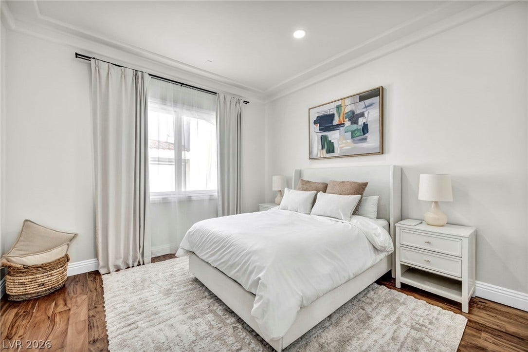 8805 Spanish Mountain Drive, Las Vegas, NV 89148 Gleaming hardwood floors and classic crown molding anchor this serene bedroom retreat.