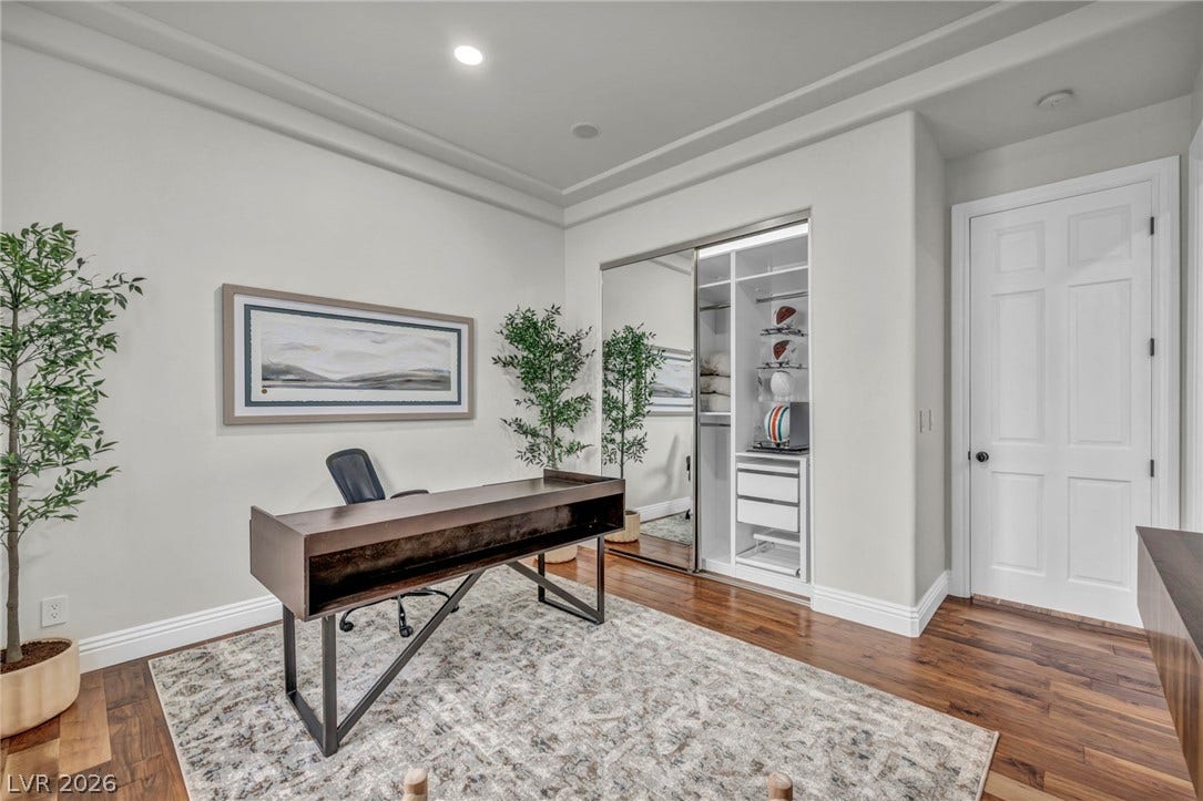8805 Spanish Mountain Drive, Las Vegas, NV 89148 Rich hardwood flooring complements the tray ceiling and crown molding in this versatile office space.