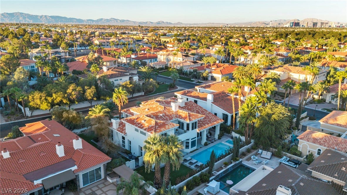 8805 Spanish Mountain Drive, Las Vegas, NV 89148 Lush palm trees and tile roofs define this upscale neighborhood shown from above.
