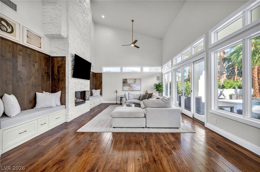 8805 Spanish Mountain Drive, Las Vegas, NV 89148 Soaring vaulted ceilings and rich wood flooring anchor this sun-drenched architectural living space.