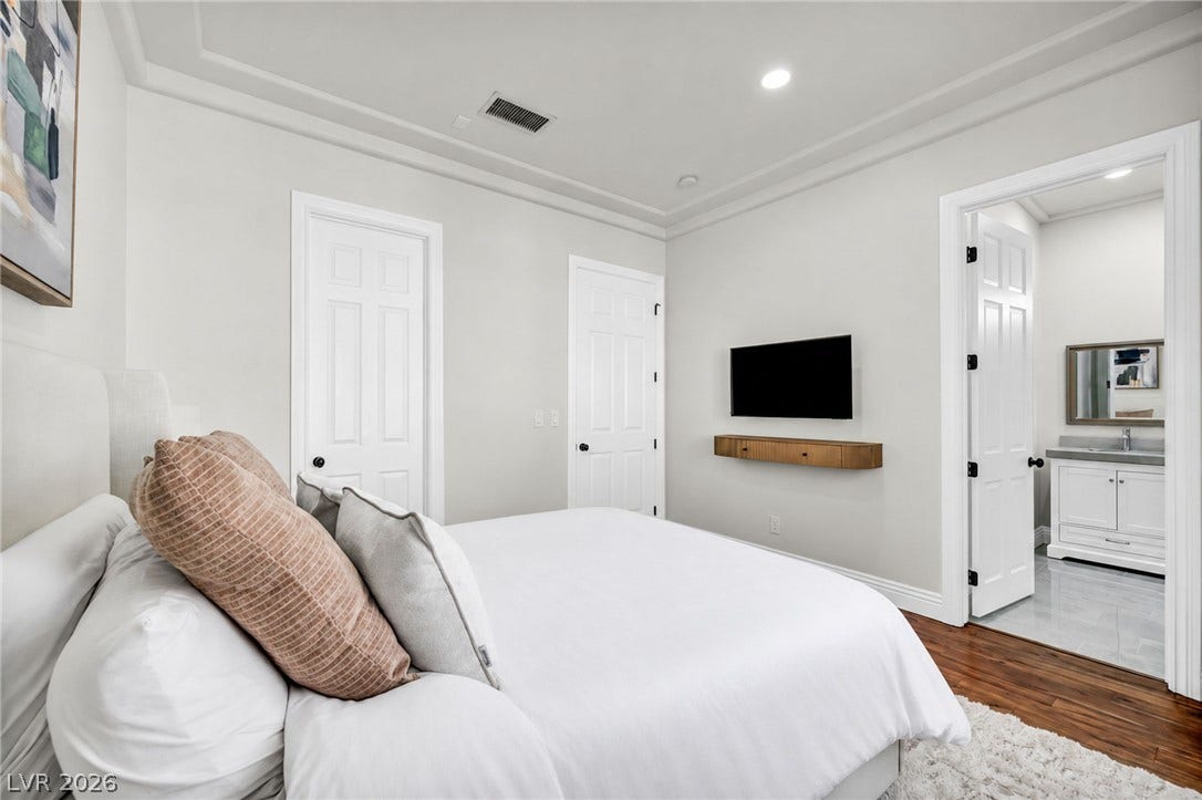 8805 Spanish Mountain Drive, Las Vegas, NV 89148 Rich hardwood floors and elegant crown molding elevate this serene bedroom suite.