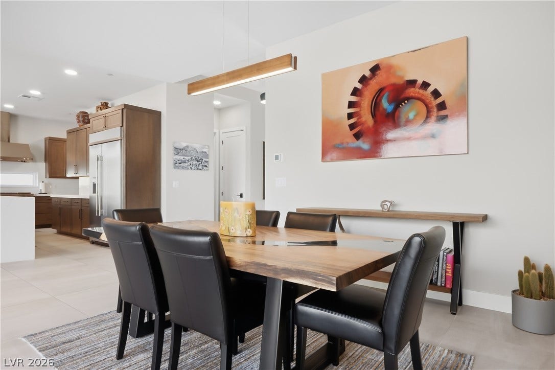 Gleaming tile floors flow from the bright dining area into the open-concept kitchen.