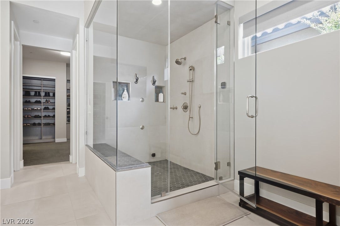 Clean lines and a spacious glass-enclosed walk-in shower define this modern, minimalist bath space.