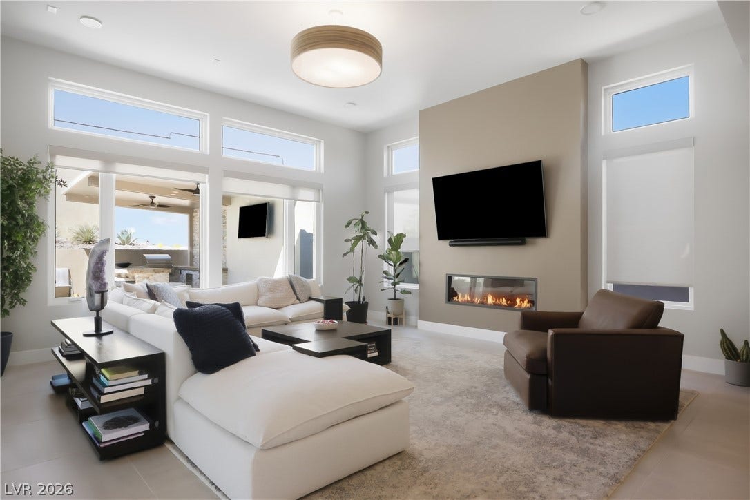 High ceilings and clerestory windows frame a linear fireplace in this modern living space.