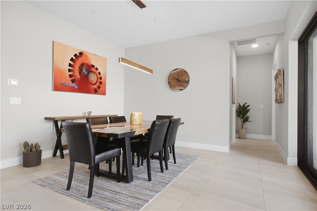 Smooth tile flooring and clean white walls define this modern formal dining area.