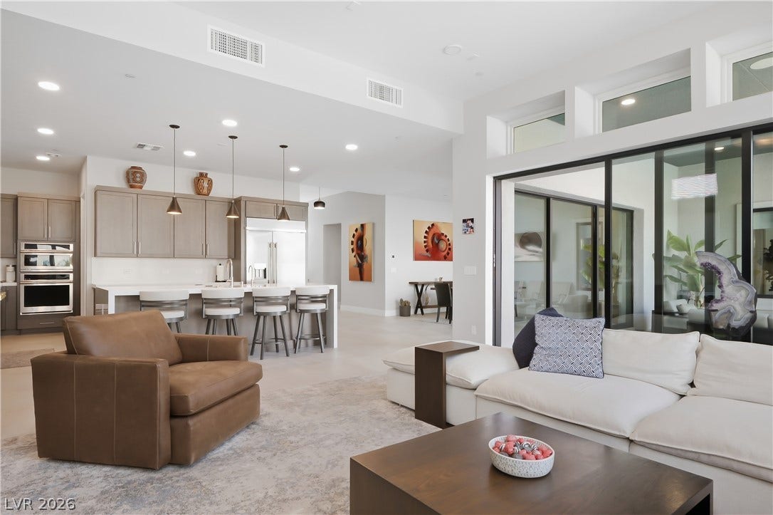 An open floorplan seamlessly connects the airy living area with a contemporary kitchen.