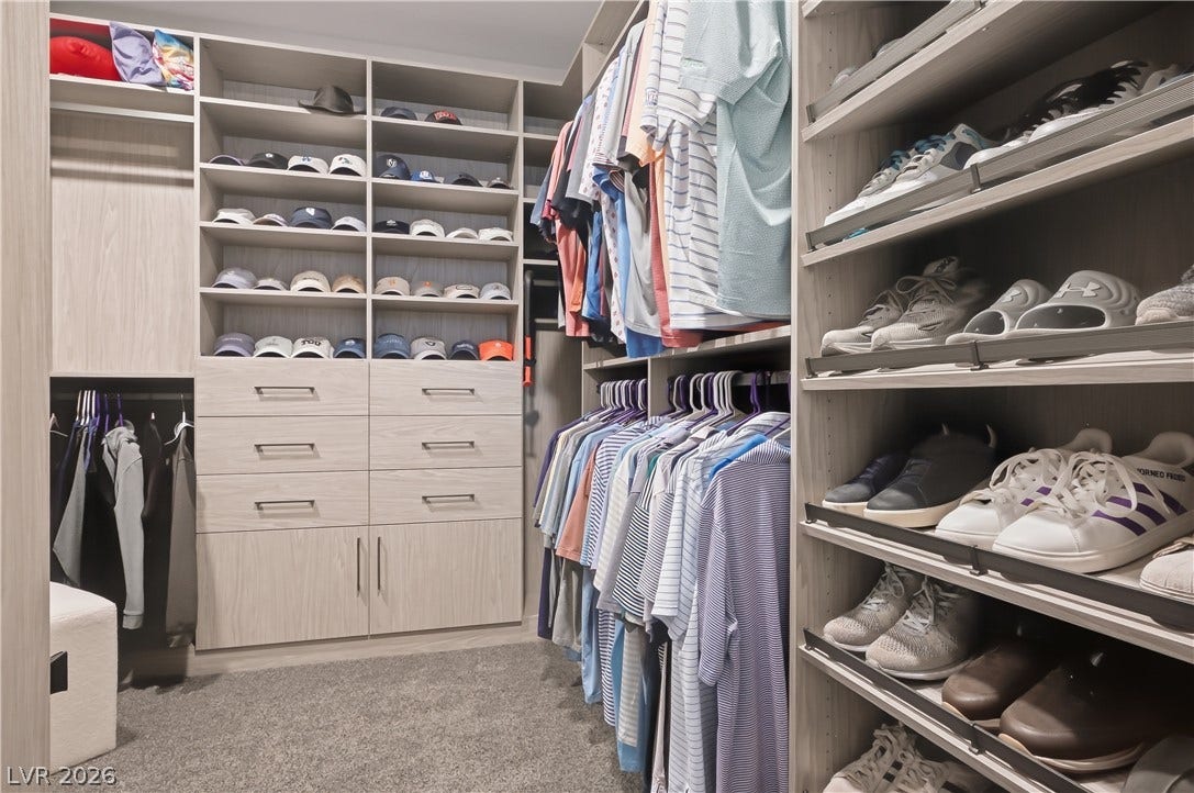 Custom built-in shelving and ample storage options maximize space in this walk-in closet.