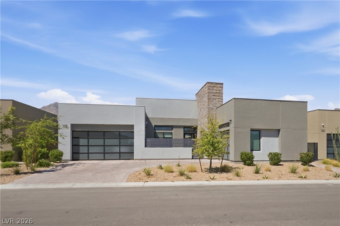 Clean architectural lines and desert landscaping define this striking contemporary home facade.