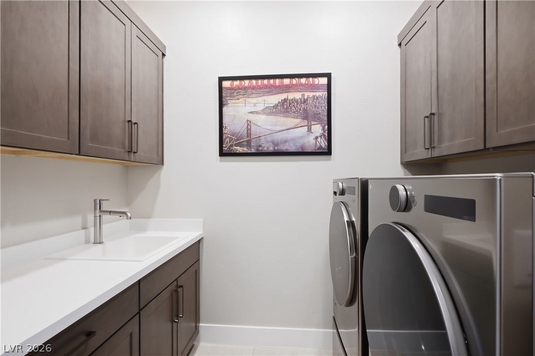 Ample cabinetry and a built-in sink optimize this highly functional utility space.