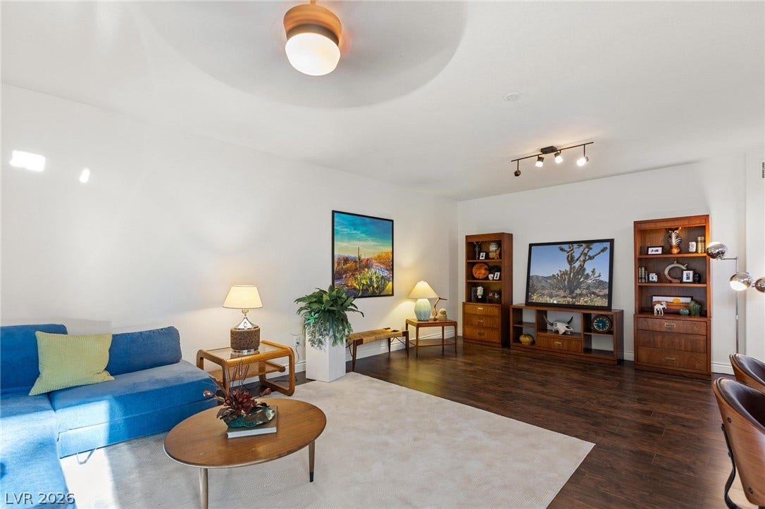 8088 Dark Hollow Place, Las Vegas, NV 89117 Rich hardwood floors complement this naturally illuminated basement, offering a perfect setting for relaxation.