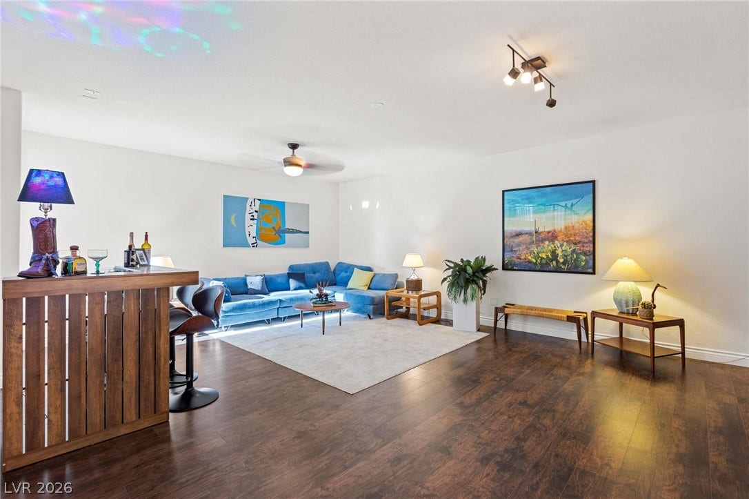 8088 Dark Hollow Place, Las Vegas, NV 89117 Rich wood flooring complements a generous, open basement, perfect for entertaining.
