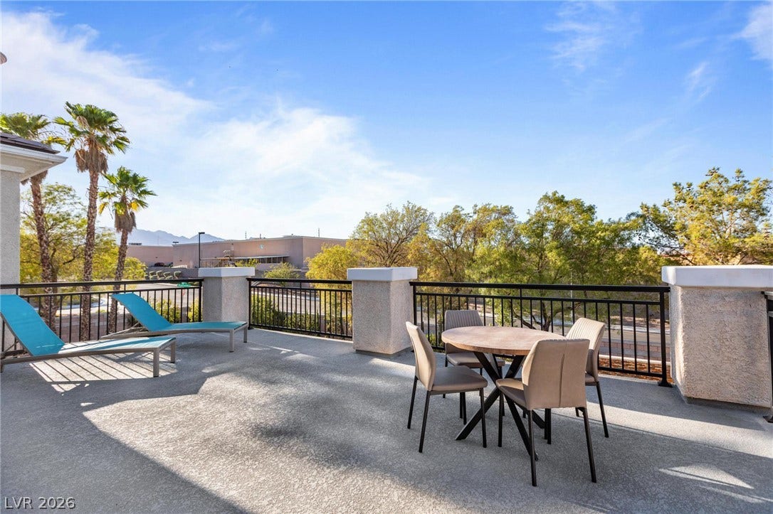 8088 Dark Hollow Place, Las Vegas, NV 89117 An inviting patio off the primary bedroom offers ample space for outdoor lounging with far-reaching views.