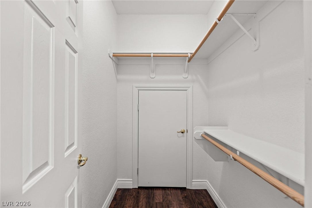 8088 Dark Hollow Place, Las Vegas, NV 89117 Organized closet space with practical shelving and hanging rods for ample storage.