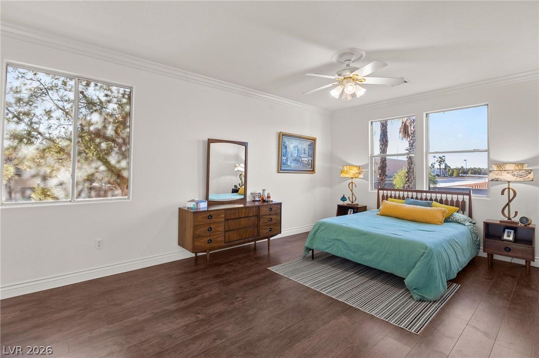 8088 Dark Hollow Place, Las Vegas, NV 89117 Well-lit sleeping quarters with rich hardwood flooring and a refreshing ceiling fan.