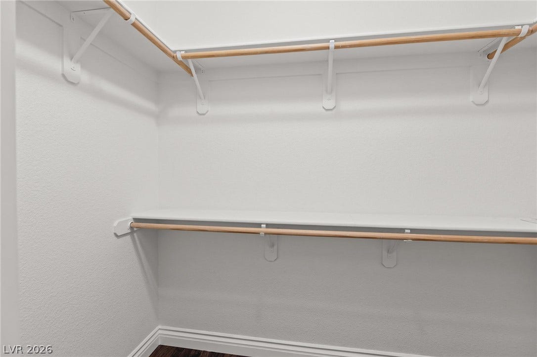 8088 Dark Hollow Place, Las Vegas, NV 89117 Ample shelving and hanging space offer practical organization within this well-appointed closet.