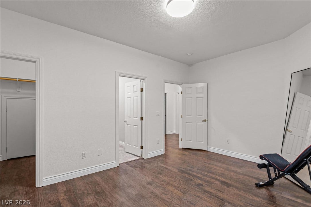 8088 Dark Hollow Place, Las Vegas, NV 89117 Rich hardwood floors create a welcoming atmosphere in this versatile room.