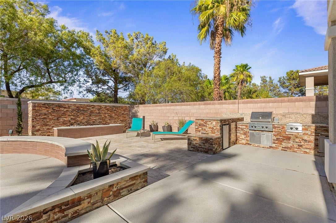 8088 Dark Hollow Place, Las Vegas, NV 89117 An outdoor oasis provides a built-in barbecue and fire pit, ideal for entertaining.