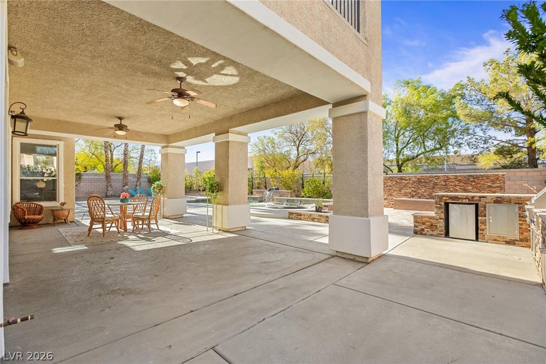 8088 Dark Hollow Place, Las Vegas, NV 89117 A spacious covered patio provides an ideal setting for outdoor entertaining, complete with a built-in outdoor kitchen and a serene water feature.