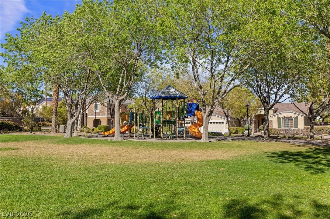 8088 Dark Hollow Place, Las Vegas, NV 89117 A vibrant neighborhood park with a colorful playground awaits behind a lush green lawn.