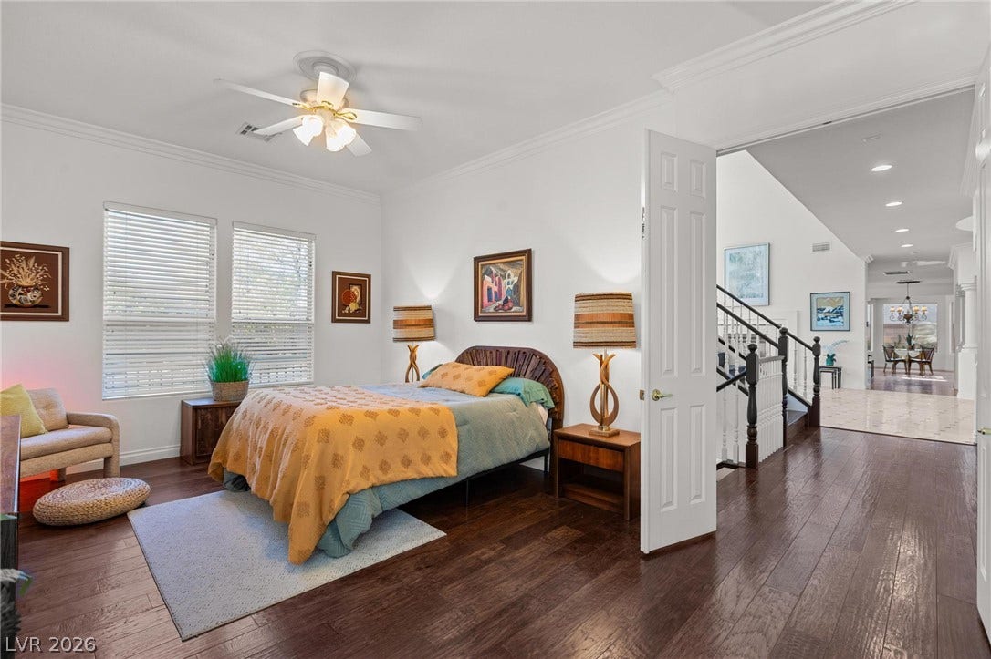 8088 Dark Hollow Place, Las Vegas, NV 89117 Rich hardwood flooring extends throughout this naturally illuminated bedroom with a ceiling fan for comfort.