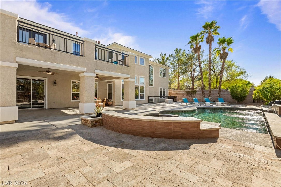 8088 Dark Hollow Place, Las Vegas, NV 89117 An inviting private pool and spa grace a generously tiled patio, perfect for outdoor leisure.