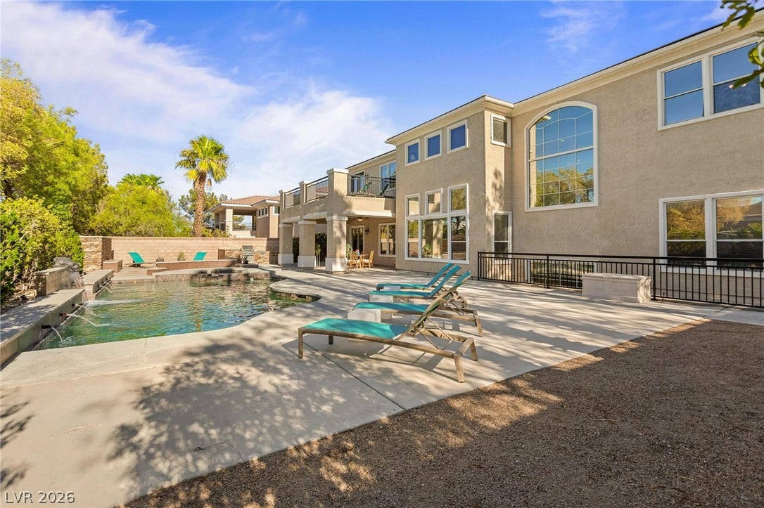 8088 Dark Hollow Place, Las Vegas, NV 89117 An inviting backyard oasis offers a sparkling pool and spa, alongside an extensive sun patio for outdoor enjoyment.