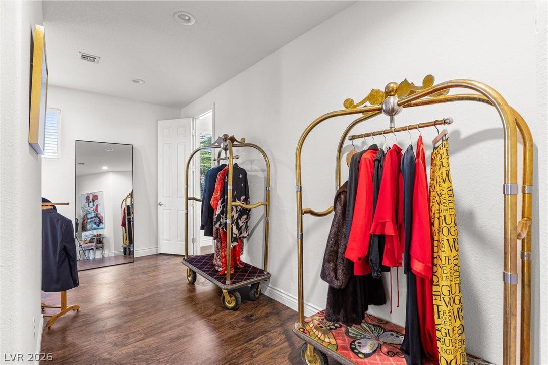 8088 Dark Hollow Place, Las Vegas, NV 89117 Rich hardwood flooring extends through this well-lit walk-in closet, perfect for organizing your wardrobe.