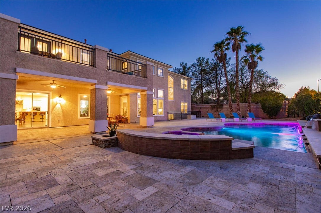 8088 Dark Hollow Place, Las Vegas, NV 89117 An inviting exterior boasts a luminous pool and spa, complementing the home's balconies and covered patio.