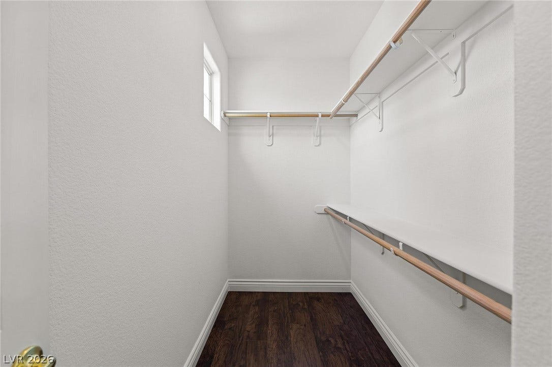 8088 Dark Hollow Place, Las Vegas, NV 89117 A well-lit walk-in closet offers ample storage and organizational potential.