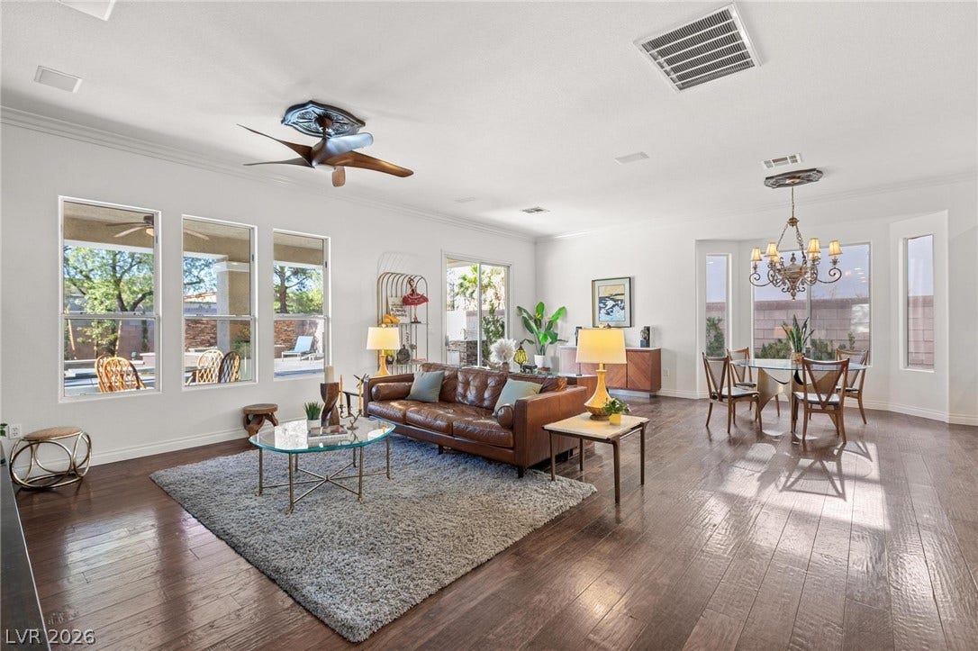 8088 Dark Hollow Place, Las Vegas, NV 89117 An inviting open-concept living space features rich hardwood flooring and abundant natural light.