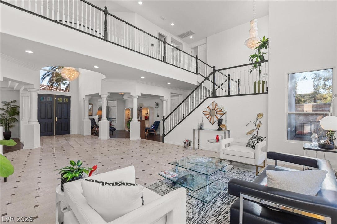8088 Dark Hollow Place, Las Vegas, NV 89117 A grand entrance with high ceilings and a sweeping staircase welcomes guests into this elegant home.