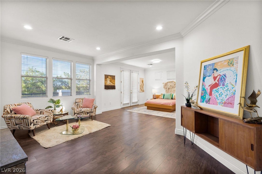 8088 Dark Hollow Place, Las Vegas, NV 89117 Rich wood flooring complements tall ceilings, creating an inviting and airy atmosphere.